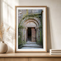 Framed Mont Saint-Michel Abbey doorway photography print displayed on a wood cabinet in a warm neutral interior