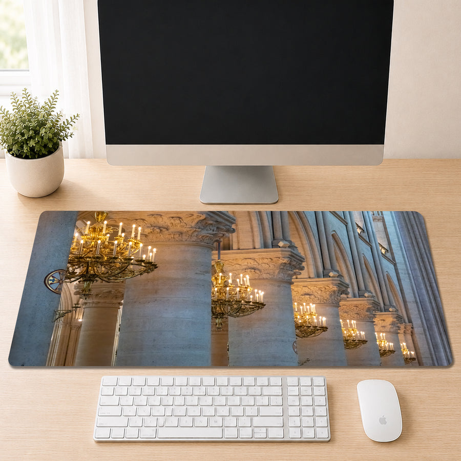 a computer desk with a monitor, keyboard, and mouse. The monitor displays a large image of a building with ornate columns and chandeliers.
