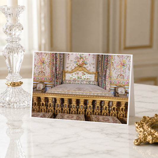 A framed photograph of an ornate, lavishly decorated bedroom with intricate gold and floral patterns on the walls and furniture.