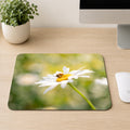 Honeybee gathering pollen on a white daisy with a soft green meadow background, printed on a mouse pad