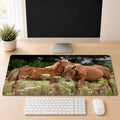 two brown horses standing in a field of flowers, with one horse appearing to be nuzzling the other.