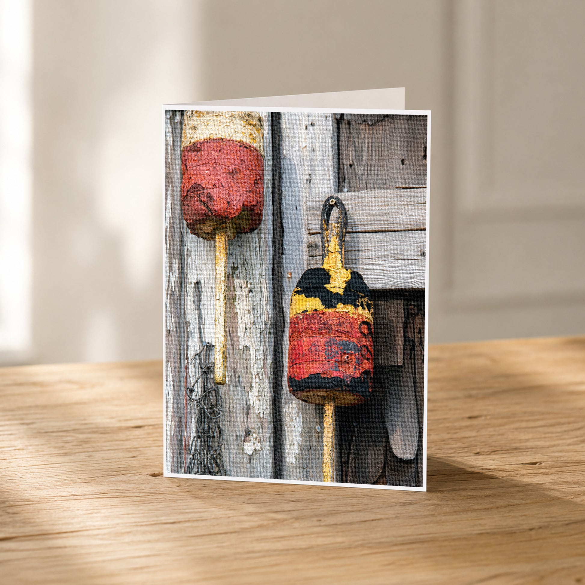 A photograph of two weathered buoys, one red and one yellow, attached to a wooden wall.