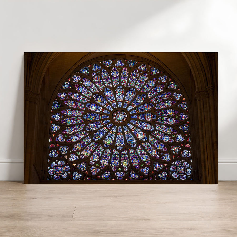 Notre-Dame rose window fine art photography print leaning against a white wall on a light wood floor.