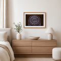 Framed Notre-Dame rose window photography print displayed above a wood dresser in a bright neutral bedroom