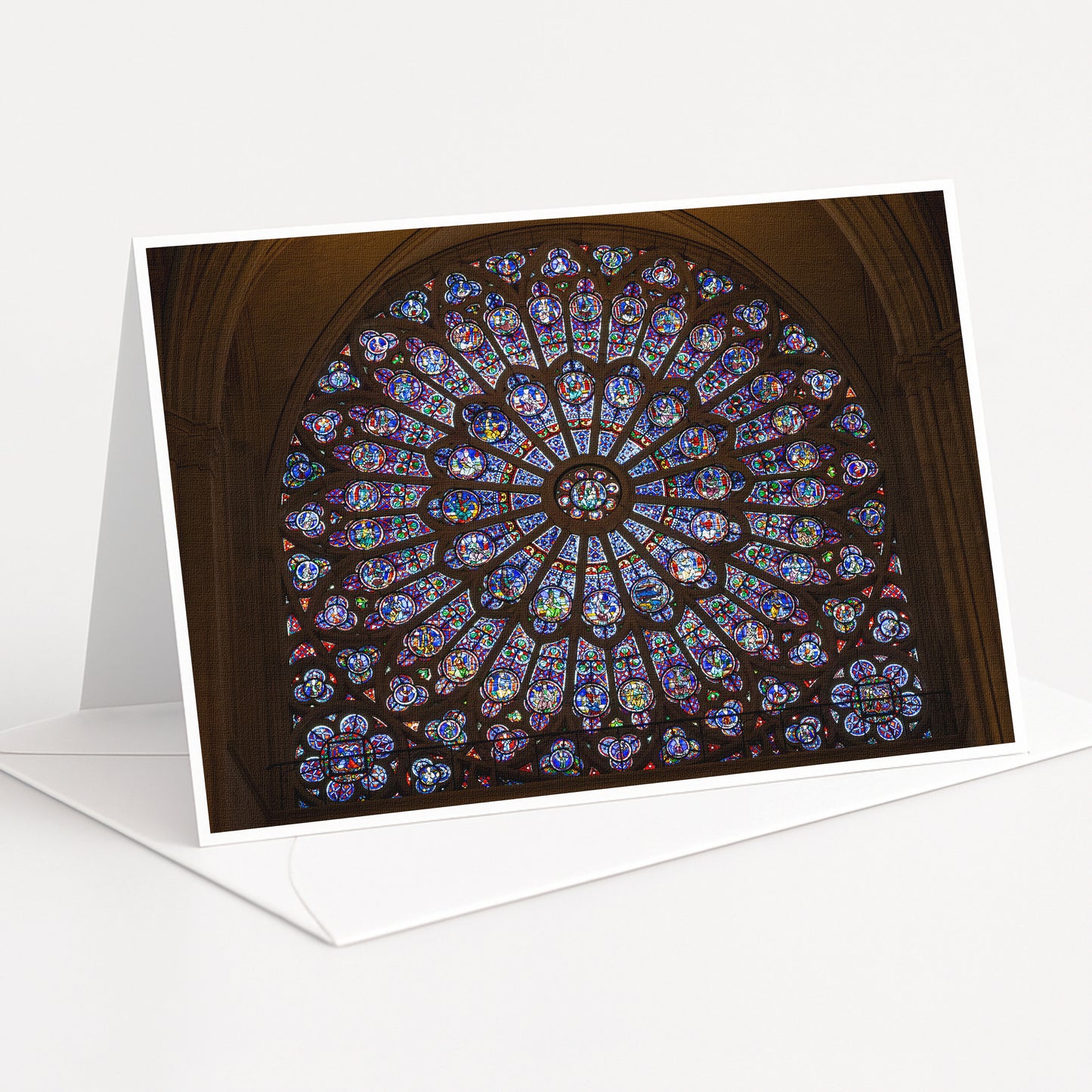 A large, colorful stained glass window with intricate patterns and designs, set within an arched structure.