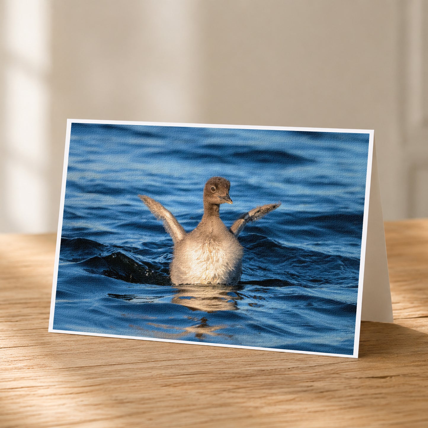 A greeting card featuring a duck swimming in the water, with its wings spread wide.