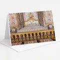 an ornate, gilded bed with intricate floral patterns and gold accents, set against a backdrop of a wall with a floral tapestry.