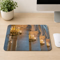 Row of gold candlelit chandeliers between Gothic stone columns inside Notre-Dame Cathedral, printed on a mouse pad