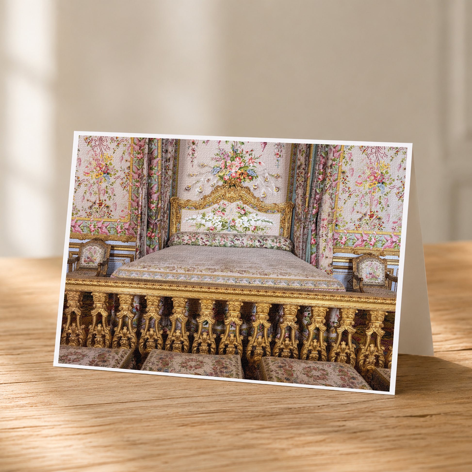 A photograph of an ornate, intricately decorated bed with gold and floral patterns, placed on a wooden surface.